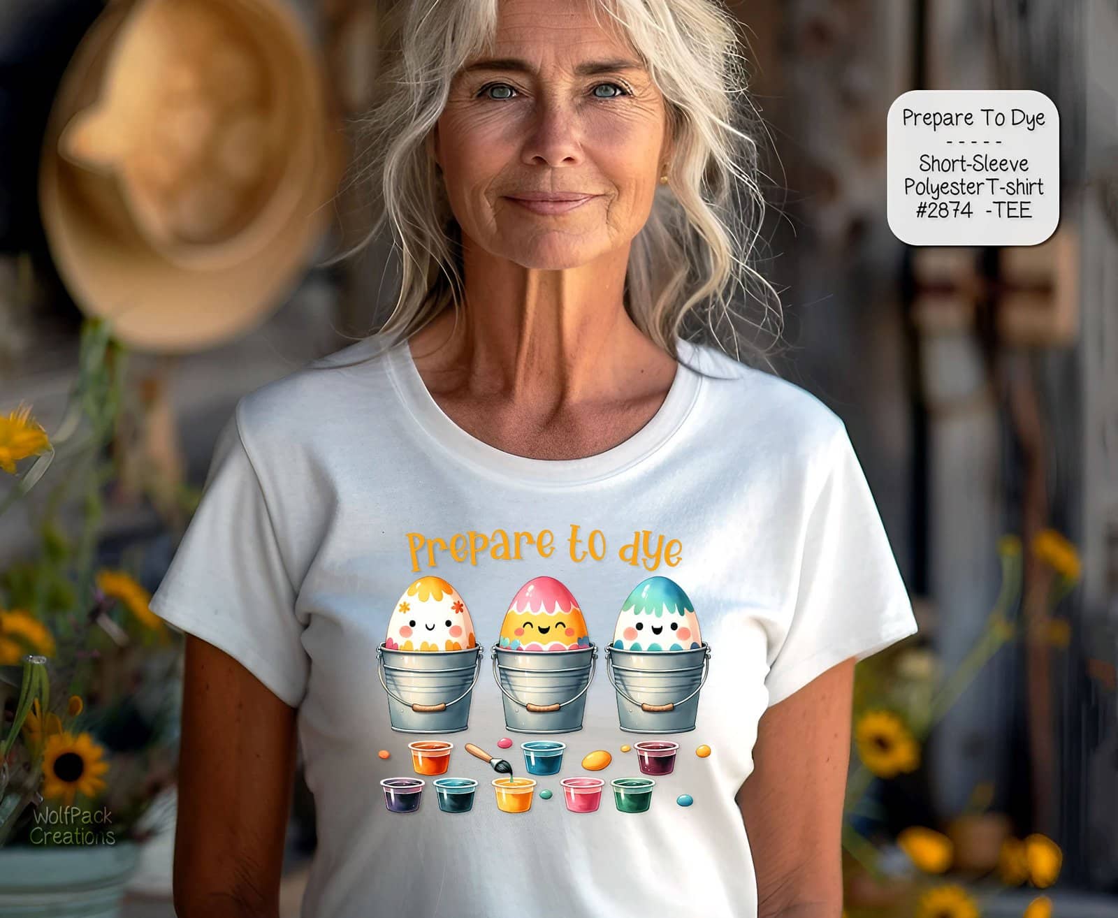 A mockup of an older woman wearing a white t-shirt displaying a row of decorated Easter eggs in little pots.