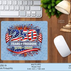 A rectangular mousepad on a wooden desk next to a keyboard and mouse, featuring the "250 Years of Freedom" firework graphic.
